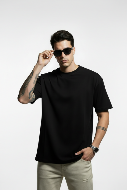 Man wearing a black t-shirt and sunglasses on a white background